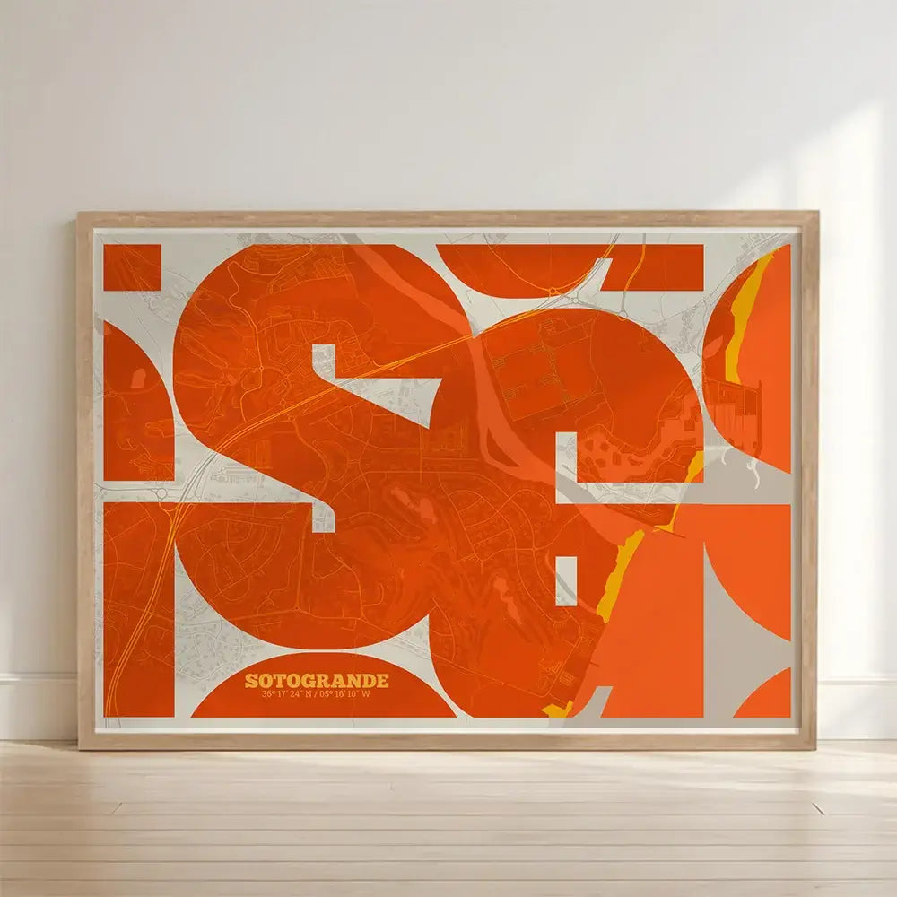 Framed Sotogrande in Inseparable design, featuring the city's abbreviation in expressive typography over a detailed urban map designed in orange and an off-white background with no border edge-to-edge print leaning against a wall