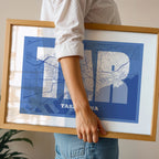 Modern interior design with a Tarragona in Super Bold design, a typographic poster where the city map is overlaid with extra-thick lettering for a modern, high-impact look designed in navy blue and white, displayed on a living room wall