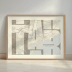 Framed Tarragona in Inseparable design, featuring the city's abbreviation in expressive typography over a detailed urban map designed in light brown and an off-white background with a white margin border in a warm lit minimalist setting