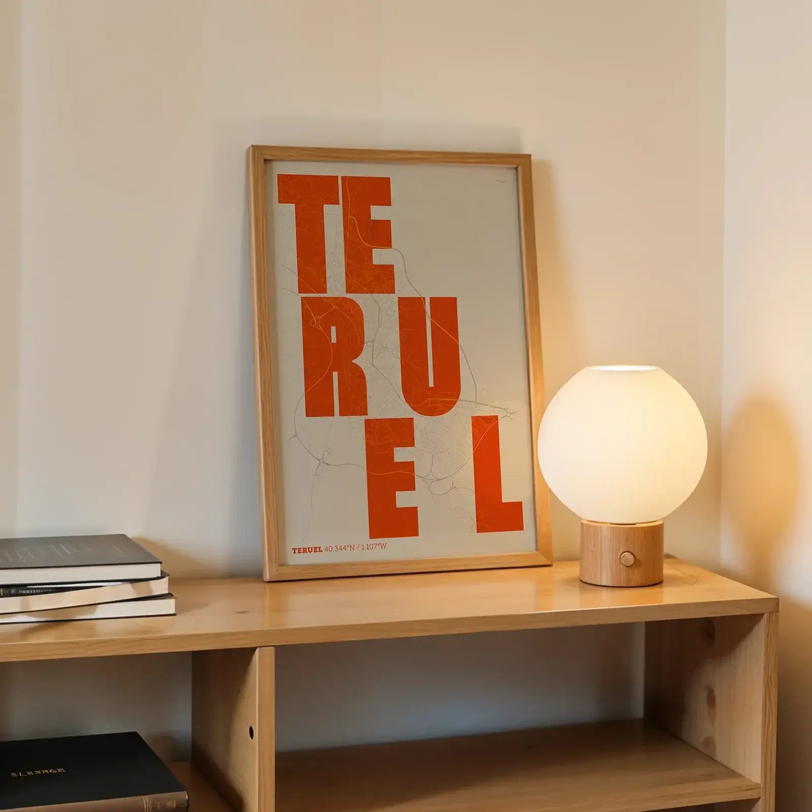 Modern interior design with a Teruel in Unruled design, where the city name letters appear randomly across different lines for a truly original urban layout designed in orange and an off-white background, displayed on a living room wall