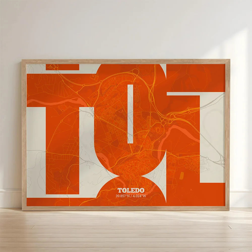 Framed Toledo in Inseparable design, featuring the city's abbreviation in expressive typography over a detailed urban map designed in orange and an off-white background with no border edge-to-edge print leaning against a wall