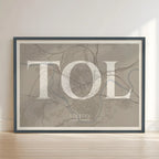 Framed Toledo in Classic design, inspired by chiseled typography with an elegant font that creates a beautiful visual contrast designed in light brown and an off-white background with no border edge-to-edge print leaning against a wall