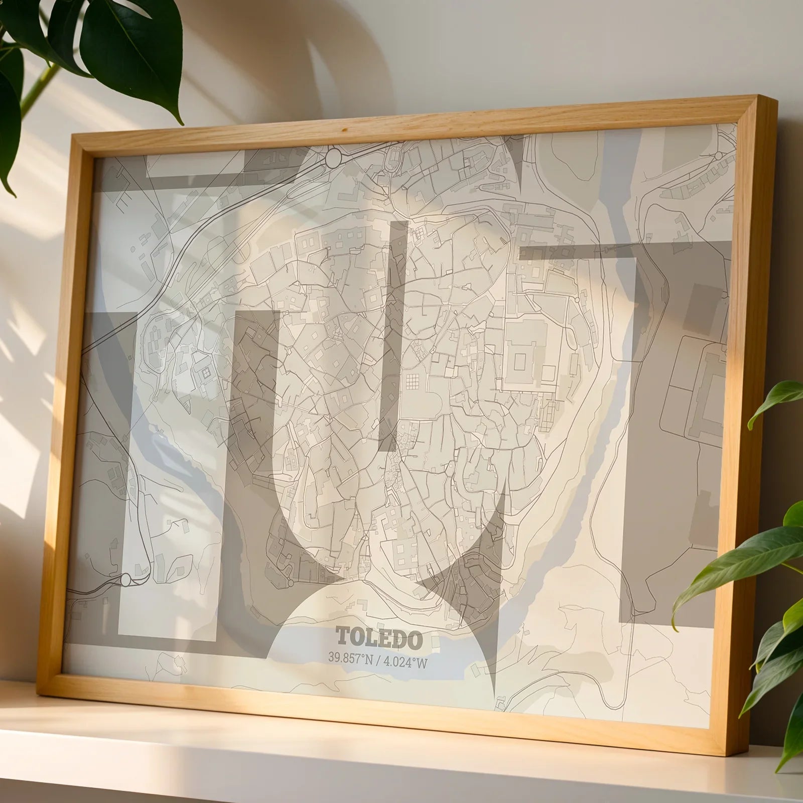 Modern interior design with a Toledo in Inseparable design, featuring the city's abbreviation in expressive typography over a detailed urban map designed in light brown and an off-white background, displayed on a living room wall