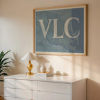 Modern interior design with a Valencia in Classic design, inspired by chiseled typography with an elegant font that creates a beautiful visual contrast designed in bluish gray and an off-white background, displayed on a living room wall