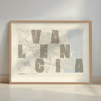 Framed Valencia in Unruled design, where the city name letters appear randomly across different lines for a truly original urban layout designed in light brown and an off-white background with a white margin border in a warm lit minimalist setting