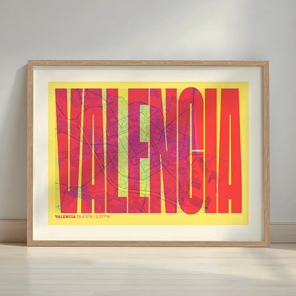 Framed Valencia in Extra Compressed design, where the letters are tightly squeezed to fit the city's map shape designed in yellow and fuchsia with a white margin border in a warm lit minimalist setting