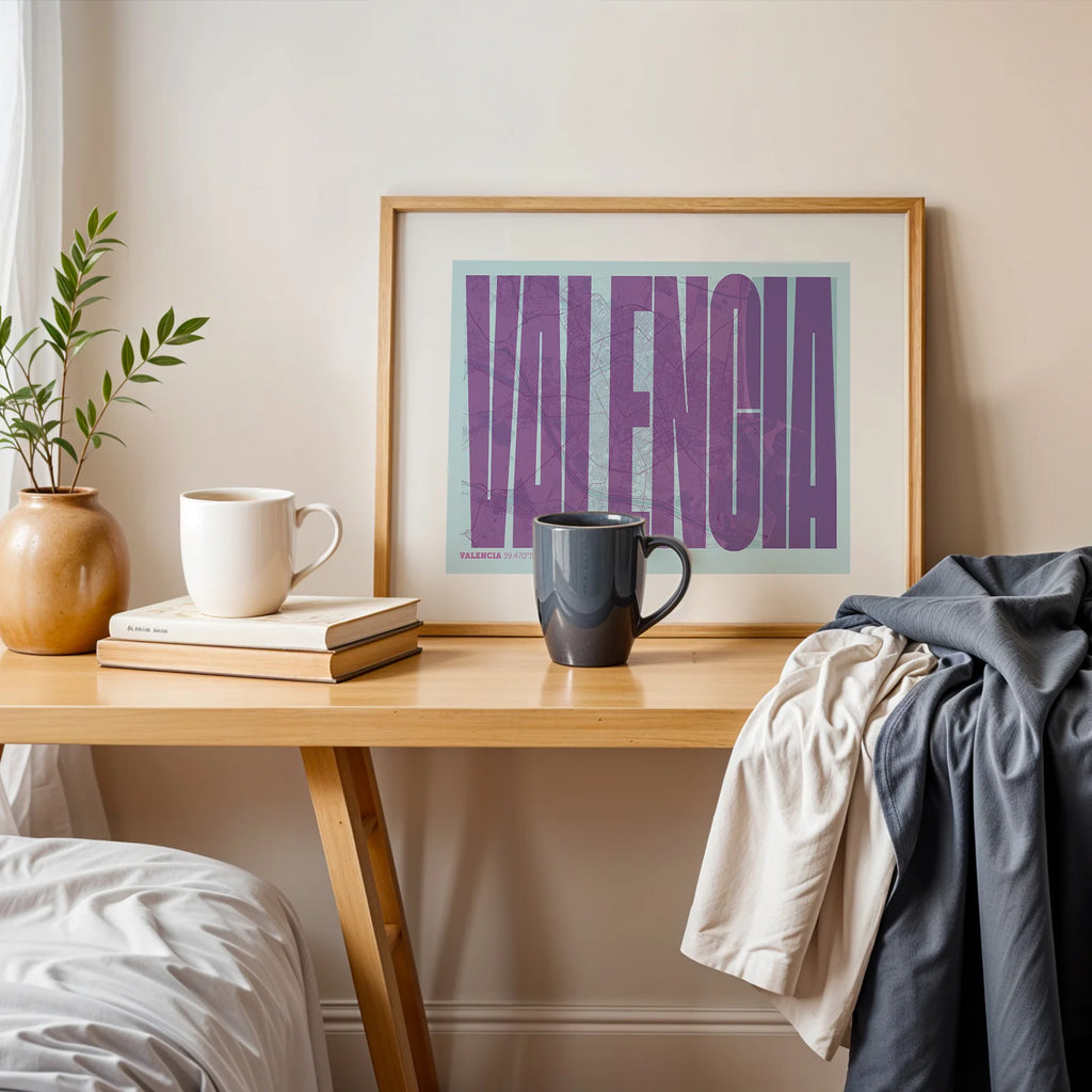 Modern interior design with a Valencia in Extra Compressed design, where the letters are tightly squeezed to fit the city's map shape designed in purple and light blue, displayed on a living room wall