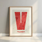 Framed Valladolid in Super Bold design, a typographic poster where the city map is overlaid with extra-thick lettering for a modern, high-impact look designed in red and an off-white background with a white margin border in a warm lit minimalist setting