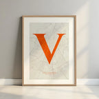 Framed Valladolid in Classic design, inspired by chiseled typography with an elegant font that creates a beautiful visual contrast designed in orange and an off-white background with a white margin border in a warm lit minimalist setting