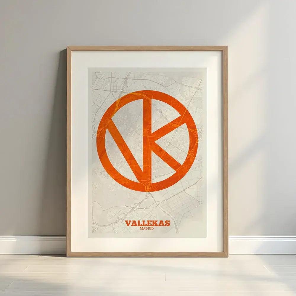 Framed Vallecas in Super Bold design, a typographic poster where the city map is overlaid with extra-thick lettering for a modern, high-impact look designed in orange and an off-white background with a white margin border in a warm lit minimalist setting