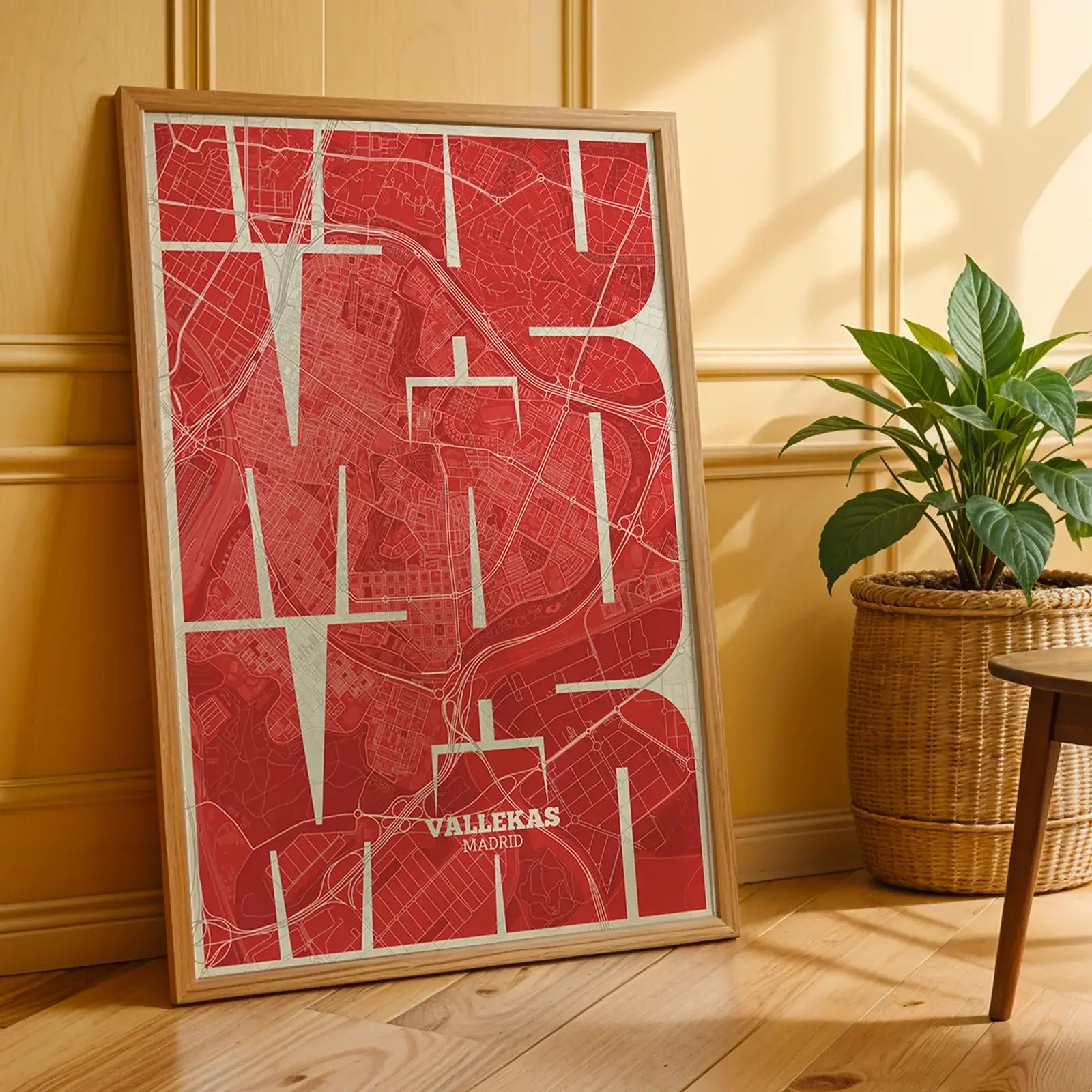Modern interior design with a Vallecas in Inseparable design, featuring the city's abbreviation in expressive typography over a detailed urban map designed in red and an off-white background, displayed on a living room wall