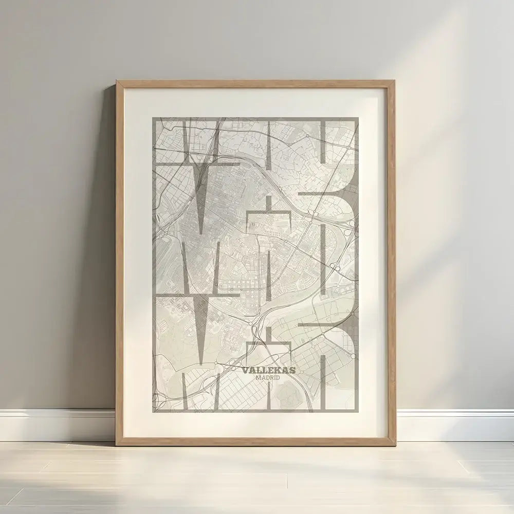 Framed Vallecas in Inseparable design, featuring the city's abbreviation in expressive typography over a detailed urban map designed in light brown and an off-white background with a white margin border in a warm lit minimalist setting