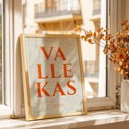 Modern interior design with a Vallecas in Classic design, inspired by chiseled typography with an elegant font that creates a beautiful visual contrast designed in orange and an off-white background, displayed on a living room wall