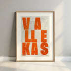 Framed Vallecas in Unruled design, where the city name letters appear randomly across different lines for a truly original urban layout designed in orange and an off-white background with a white margin border in a warm lit minimalist setting
