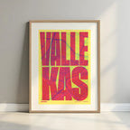 Framed Vallecas in Extra Compressed design, where the letters are tightly squeezed to fit the city's map shape designed in yellow and fuchsia with a white margin border in a warm lit minimalist setting