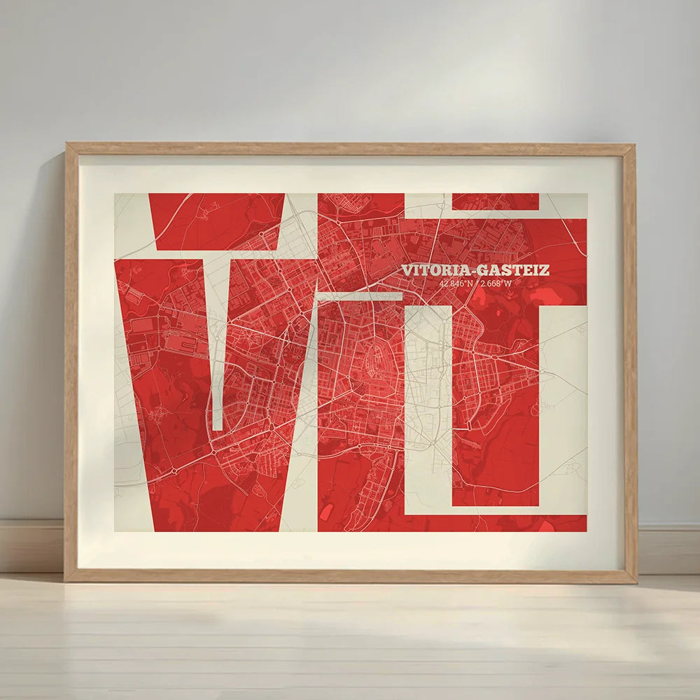 Framed Vitoria-Gasteiz in Inseparable design, featuring the city's abbreviation in expressive typography over a detailed urban map designed in red and an off-white background with a white margin border in a warm lit minimalist setting