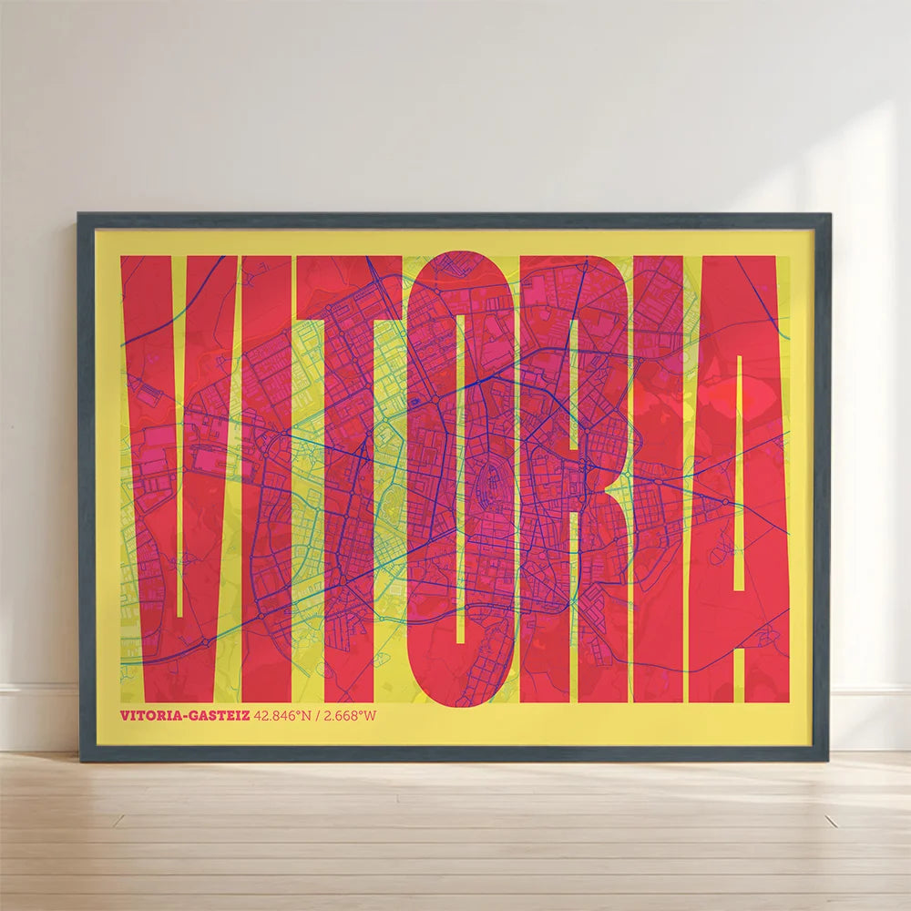 Framed Vitoria-Gasteiz in Extra Compressed design, where the letters are tightly squeezed to fit the city's map shape designed in yellow and fuchsia with no border edge-to-edge print leaning against a wall