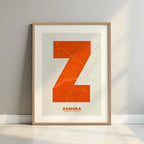 Framed Zamora in Super Bold design, a typographic poster where the city map is overlaid with extra-thick lettering for a modern, high-impact look designed in orange and an off-white background with a white margin border in a warm lit minimalist setting