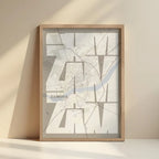 Framed Zamora in Inseparable design, featuring the city's abbreviation in expressive typography over a detailed urban map designed in light brown and an off-white background with no border edge-to-edge print leaning against a wall