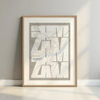 Framed Zamora in Inseparable design, featuring the city's abbreviation in expressive typography over a detailed urban map designed in light brown and an off-white background with a white margin border in a warm lit minimalist setting