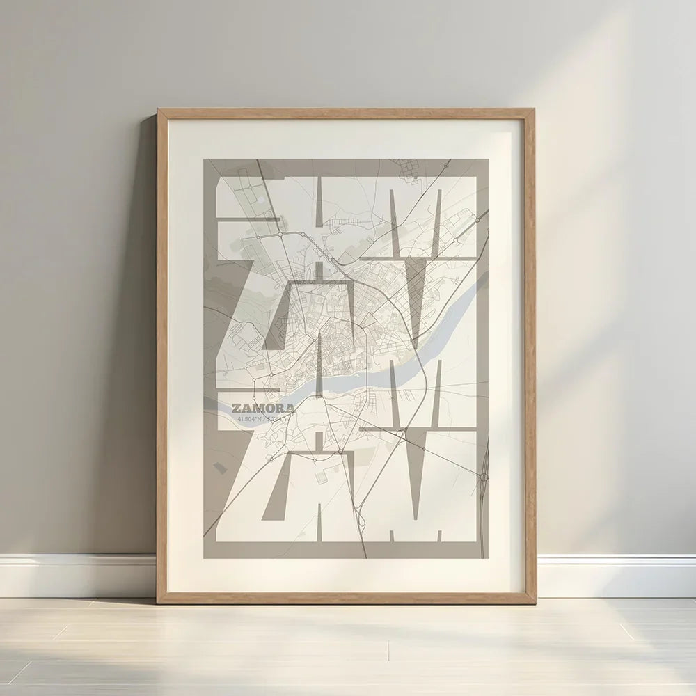 Framed Zamora in Inseparable design, featuring the city's abbreviation in expressive typography over a detailed urban map designed in light brown and an off-white background with a white margin border in a warm lit minimalist setting