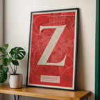 Modern interior design with a Zaragoza in Classic design, inspired by chiseled typography with an elegant font that creates a beautiful visual contrast designed in red and an off-white background, displayed on a living room wall