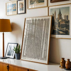 Modern interior design with a Zaragoza in Extra Compressed design, where the letters are tightly squeezed to fit the city's map shape designed in light brown and an off-white background, displayed on a living room wall